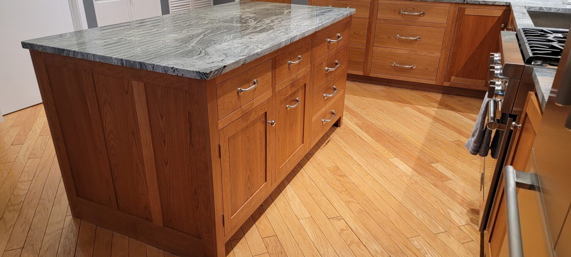 A kitchen with Cherry cabinets and granite counter tops.