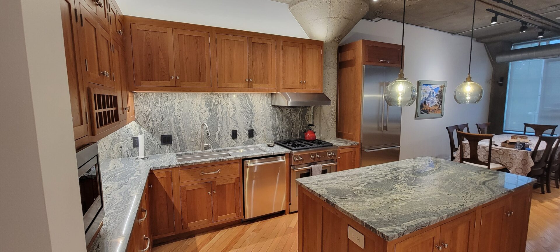 A kitchen with Cherry cabinets and granite counter tops.