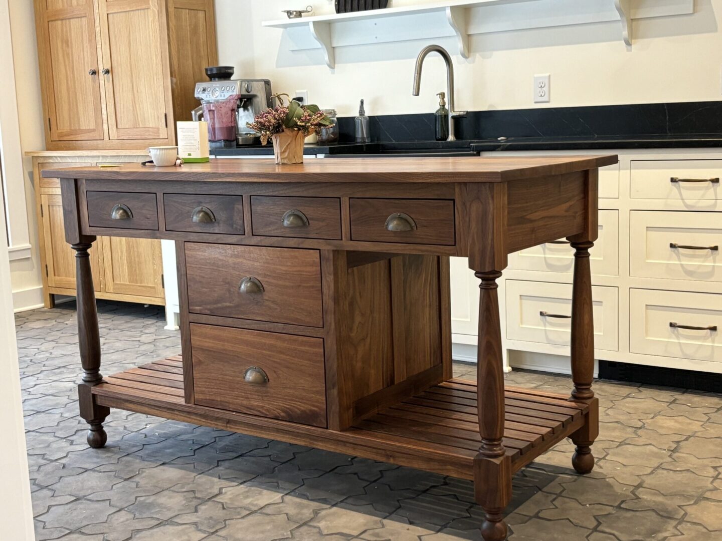 A kitchen island with drawers and a sink.